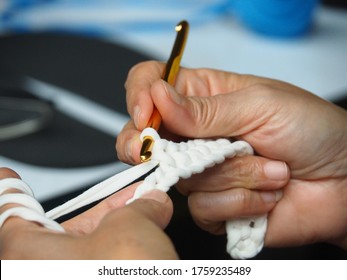 Woman's Hand  Knitting Crochet  To Make Slipper.   Hand Craft Work. Finger Exercises Activity. Hobby  Art  Craft  Background Concept.