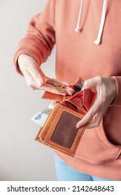 A Woman's Hand Lays Down Metal Coins Of Russian Rubles Into A Worn Leather Wallet