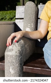 woman's hand lies on a stone armrest. High quality photo - Shutterstock ID 2174324047