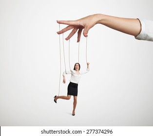 womans hand manipulating the small puppet over light grey background