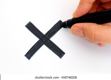 Womans Hand With Marker Drawing Black X Mark On White Background.