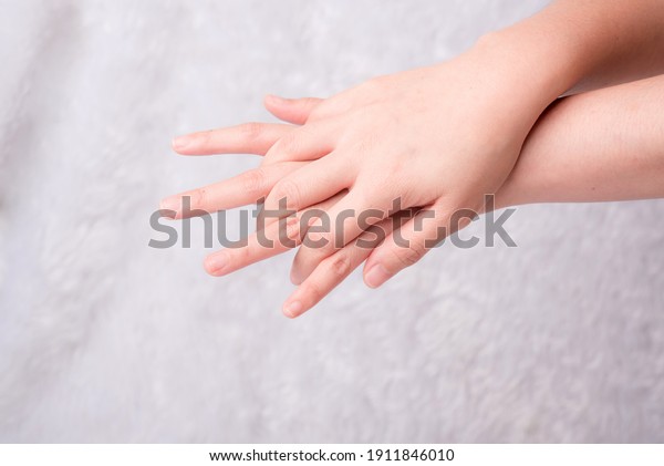 Woman\'s\
hand measuring invisible items. Isolated on\
white