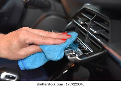 Woman's Hand With Microfiber Cloth Cleaning Car Console