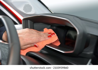 Woman's Hand With Microfiber Cloth Cleaning Car Console