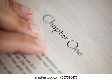 Woman's Hand On Book Page With Title 