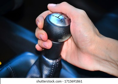 woman's hand on manual gear shift knob