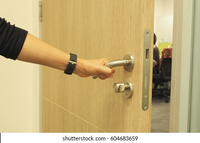 Woman's Hand Open The Private Office's Door With Do Not Disturb Sign On The Door, Coming To Work