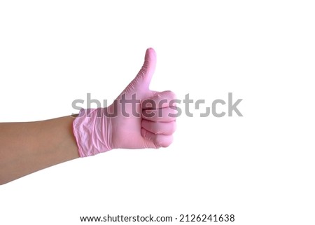 a woman's hand in a pink medical glove shows an approving gesture, a thumbs up. Stand-alone layout on a white background