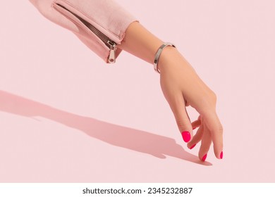 Womans hand with pink nail design. Manicure, pedicure beauty salon concept. Trendy color