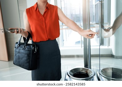 Woman's hand presses the elevator button