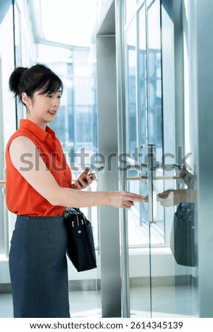 Woman's hand presses the elevator button