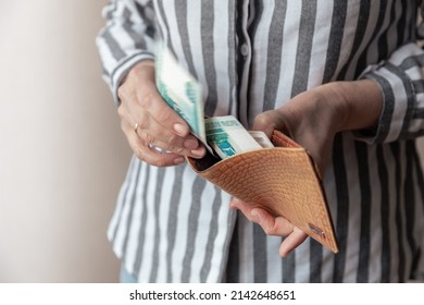 Woman's Hand Pulls Banknotes Of One Thousand Russian Rubles Out Of Worn Leather Wallet