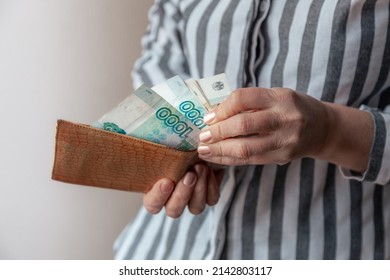 Woman's Hand Pulls Various Banknotes Of Russian Rubles Out Of Worn Leather Wallet