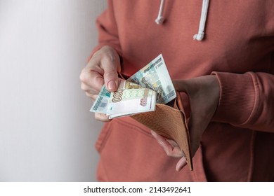 Woman's Hand Pulls Various Banknotes Of Russian Rubles Out Of Worn Leather Wallet