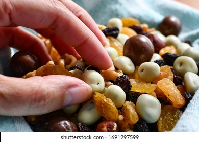 Woman's Hand Reaching For Trail Mix