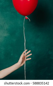 woman's hand releases the red ball. - Shutterstock ID 588835142