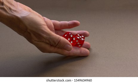 Womans Hand Rolling Red Dice