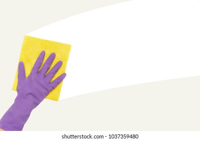 Woman's hand in rubber protective glove wiping white wall from dust with dry rag. Ceaning service or regular clean up concept