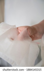 A Woman's Hand As She Holds Dryer Sheets For Laundry