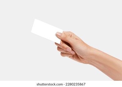 Woman's hand showing credit card, or card, or business card or voucher, isolated on white background, template, mock-up