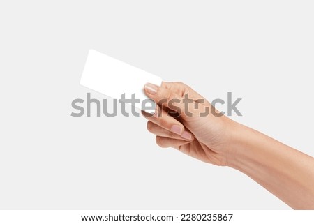 Woman's hand showing credit card, or card, or business card or voucher, isolated on white background, template, mock-up