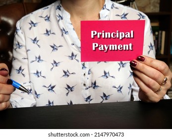 Woman's Hand Showing Pink Business Card With Phrase Principal Payment - Closeup Shot On Grey Background
