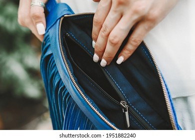 Woman's hand shows an open bag inside. Fanny pack Leather belt bag Crossbody waist purse Bum bag in soft black leather with fringe.