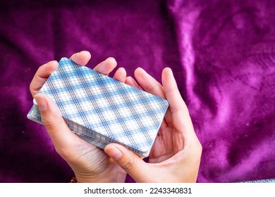 Woman's hand shuffling tarot cards