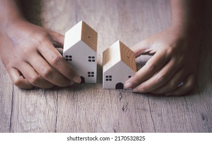 Woman's hand with a small house in hand, vintage style. - Shutterstock ID 2170532825