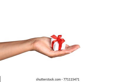 Woman's Hand With A Small White Gift Box With Bow Isolated On White Background