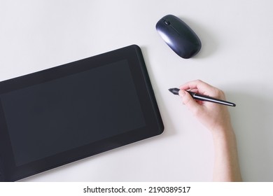 Woman's Hand And Stylus Next To Graphics Tablet And Computer Mouse. White Background. The Concept Of Modern Creativity Through Digital Technology. Copy Space. Close-up