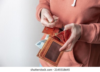 A Woman's Hand Takes Out Metal Coins Of Russian Rubles From A Worn Leather Wallet