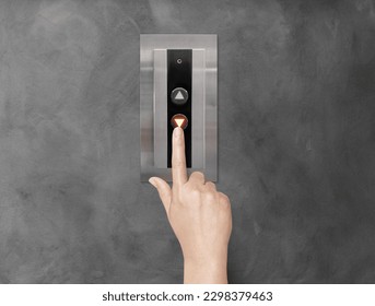 A woman's hand is using her finger to press the elevator button. - Powered by Shutterstock