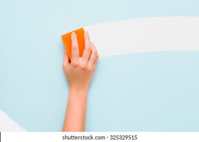 Woman's Hand Washing Wall By The Sponge