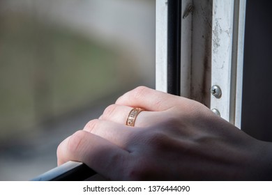A woman's hand with a wedding ring. - Shutterstock ID 1376444090