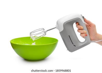 Woman's hand whipping eggs in the green bowl by electric mixer. Isolated on white. Close up. - Powered by Shutterstock