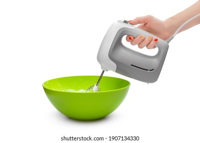 Woman's hand whipping eggs in the green bowl by electric mixer. Isolated on white. Close up. - Powered by Shutterstock