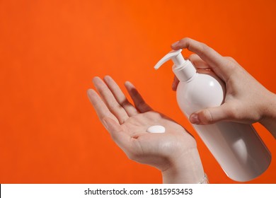 Woman's Hands Applying Lotion Isolated Over Background