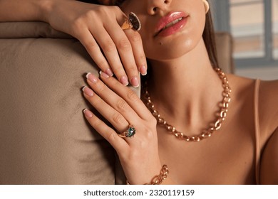 woman's hands close up wearing rings, bracelets and necklace. Modern accessories. Elegant lifestyle. 