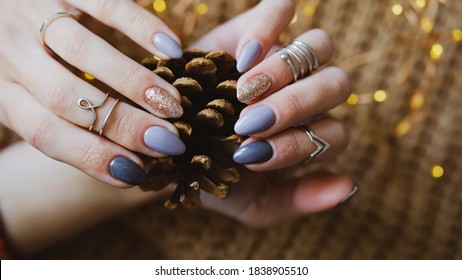 Woman's hands with colorful pattern on the nails. 2021 colors trend. Top view. Place for text. Cozy winter design.