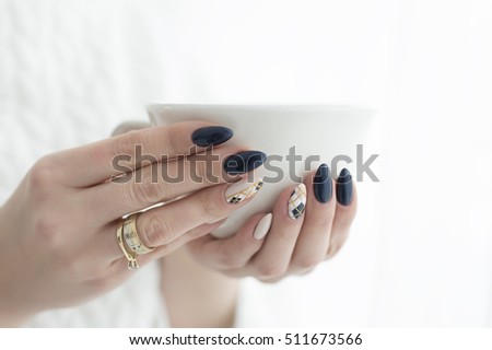 woman's hands with a cup of hot drink