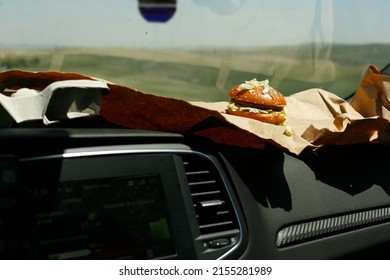 Woman's Hands Eating A Hamburger Inside A Car, Fast Food.