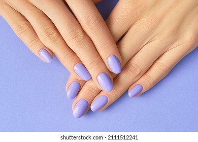 Womans hands with fashionable very peri manicure. Spring summer nail design