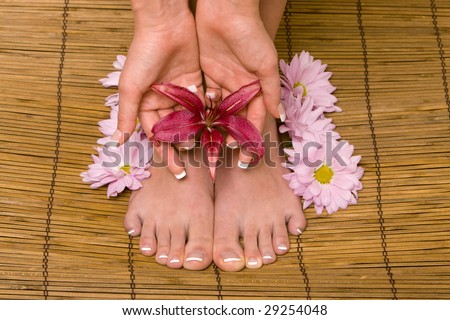 Woman's hands and feet with flowers