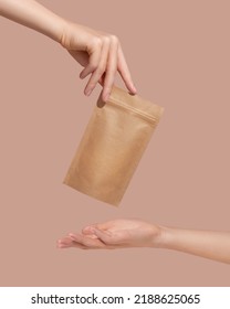 Woman's hands hold cardboard packages for tea or snacks on a beige background. Tea branding and packaging mockup. High quality photo - Shutterstock ID 2188625065