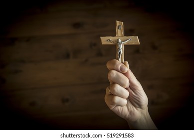 Woman's hands holding Catholic crucifix - Shutterstock ID 519291583