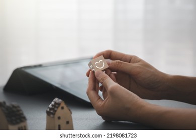 Woman's Hands Holding Wooden Cube Show Happy Face Side For Satisfaction, Mental Health Assessment