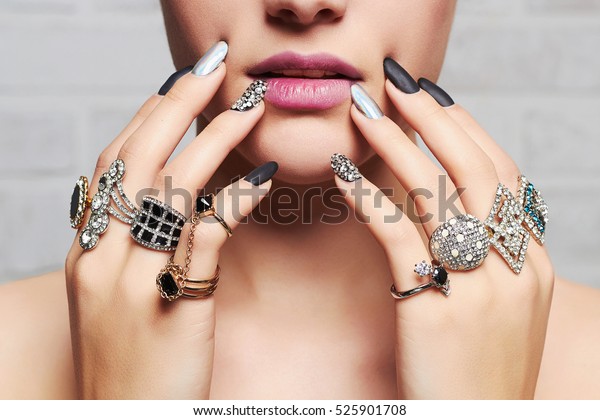 woman\'s hands with jewelry\
rings.close-up beauty and fashion portrait. girl make-up and\
manicure
