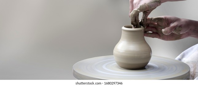Woman's hands making ceramic cup on potter's wheel - Shutterstock ID 1680297346