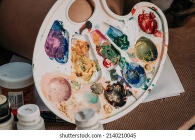 A Woman's Hands Mixing Paints On A Palette Board. Preparing To Paint A Picture. Artistic Tools. The Creative Process.